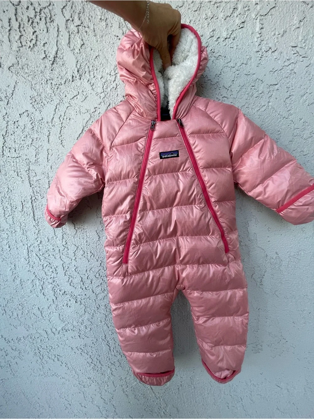 Patagonia coral pink baby snowsuit with faux-fur trim